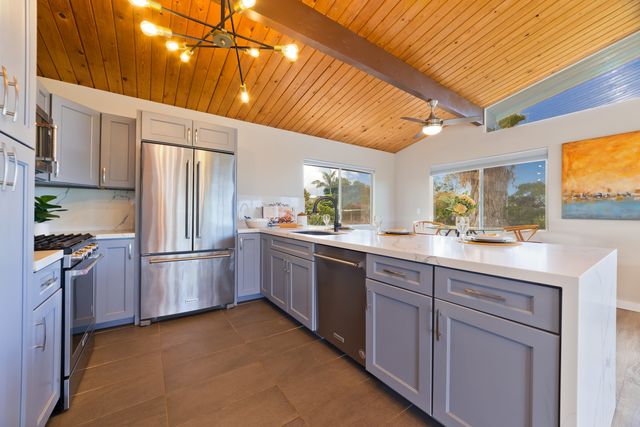 a kitchen with refrigerator and cabinets