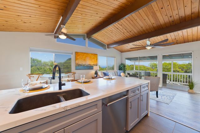 a kitchen with a sink and a large window