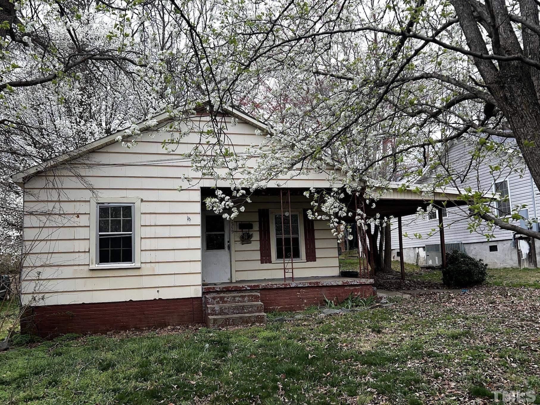 1259 Pointer Street Roxboro, NC 27573 - Photo 1 of 47 a front view of a house with a yard
