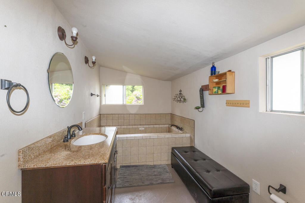 14480 Docker Hill Road Comptche, CA 95427 - Photo 11 of 27 a bathroom with a granite countertop sink mirror and a bathtub