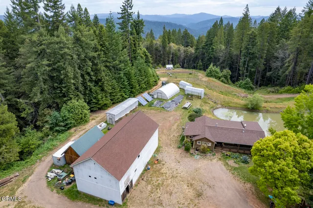 an aerial view of a house with yard