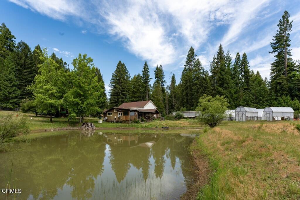 14480 Docker Hill Road Comptche, CA 95427 - Photo 18 of 27 a view of a lake with a house in the background