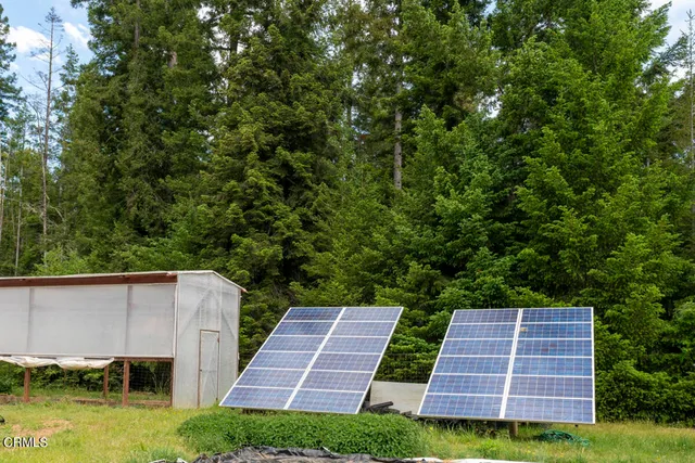 a backyard of a house with yard and outdoor seating