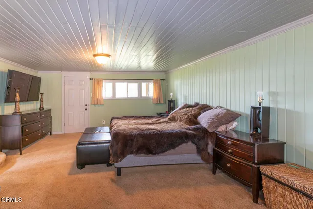 a bedroom with furniture and a window