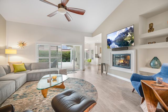 a living room with furniture fireplace and window