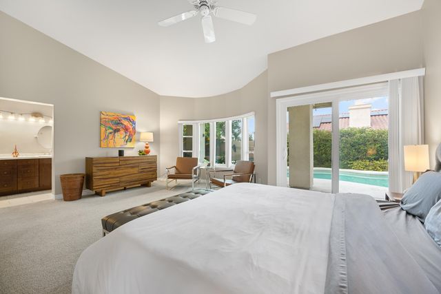 a bed room with two beds and a large window