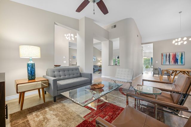 a living room with furniture and a lamp