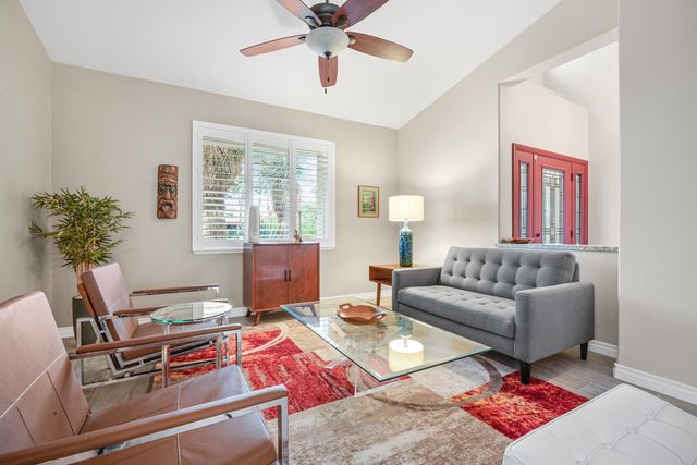 a living room with furniture and a potted plant