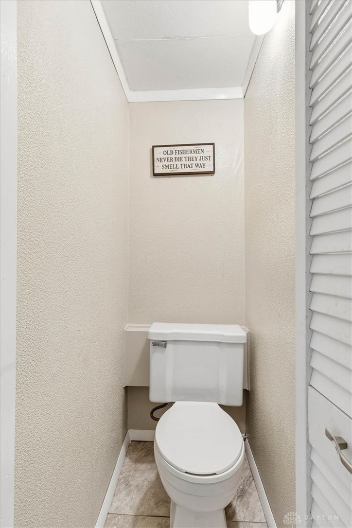 246 North Orchard Island Road Russells Point, OH 43348 - Photo 21 of 43 This cozy powder room features efficient design with tiled flooring.