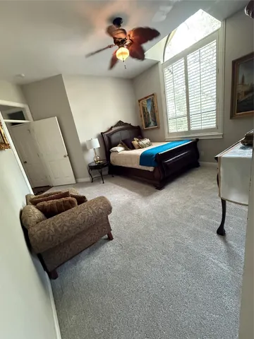 a bed sitting in a bedroom next to a window