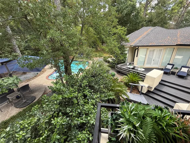 a view of a house with swimming pool and sitting area