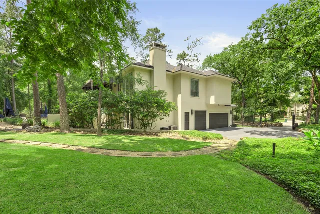 a view of a house with brick walls and a small yard