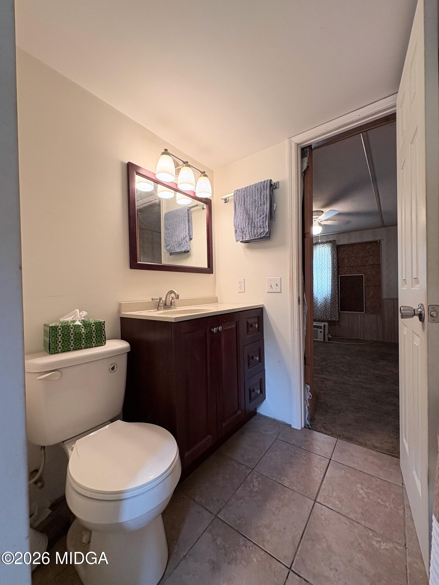 346 Quail Run Road Roberta, GA 31078 - Photo 7 of 15 a bathroom with a toilet sink and mirror