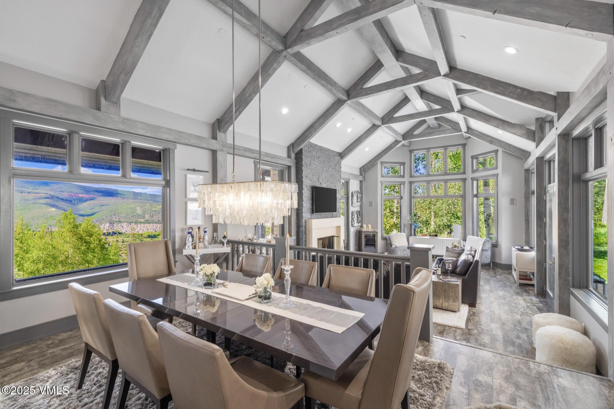 25 West Timber Drive Edwards, CO 81632 - Photo 5 of 55 a dining room with wooden floor a chandelier a glass table and chairs