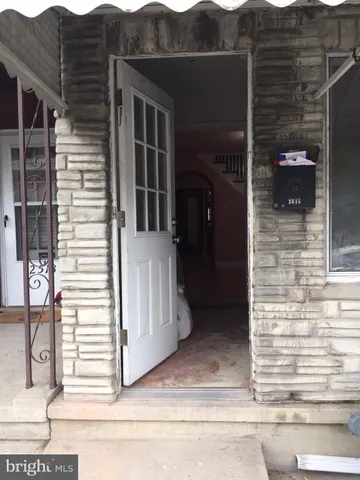 a view of a house with a door and wooden floor