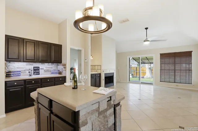 a kitchen with a sink a stove and cabinets