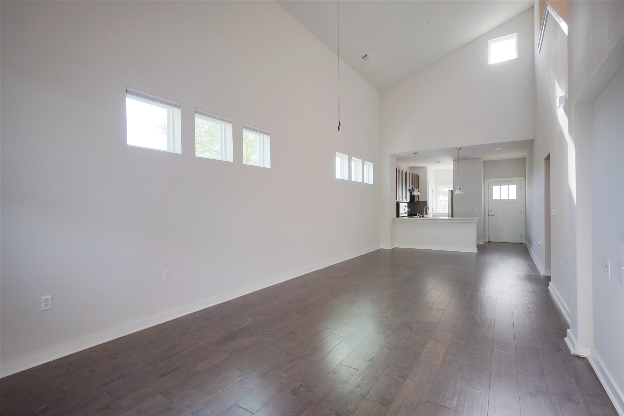 8945 Parker Ranch Circle, Unit A Austin, TX 78748 - Photo 2 of 25 an empty room with wooden floor and windows