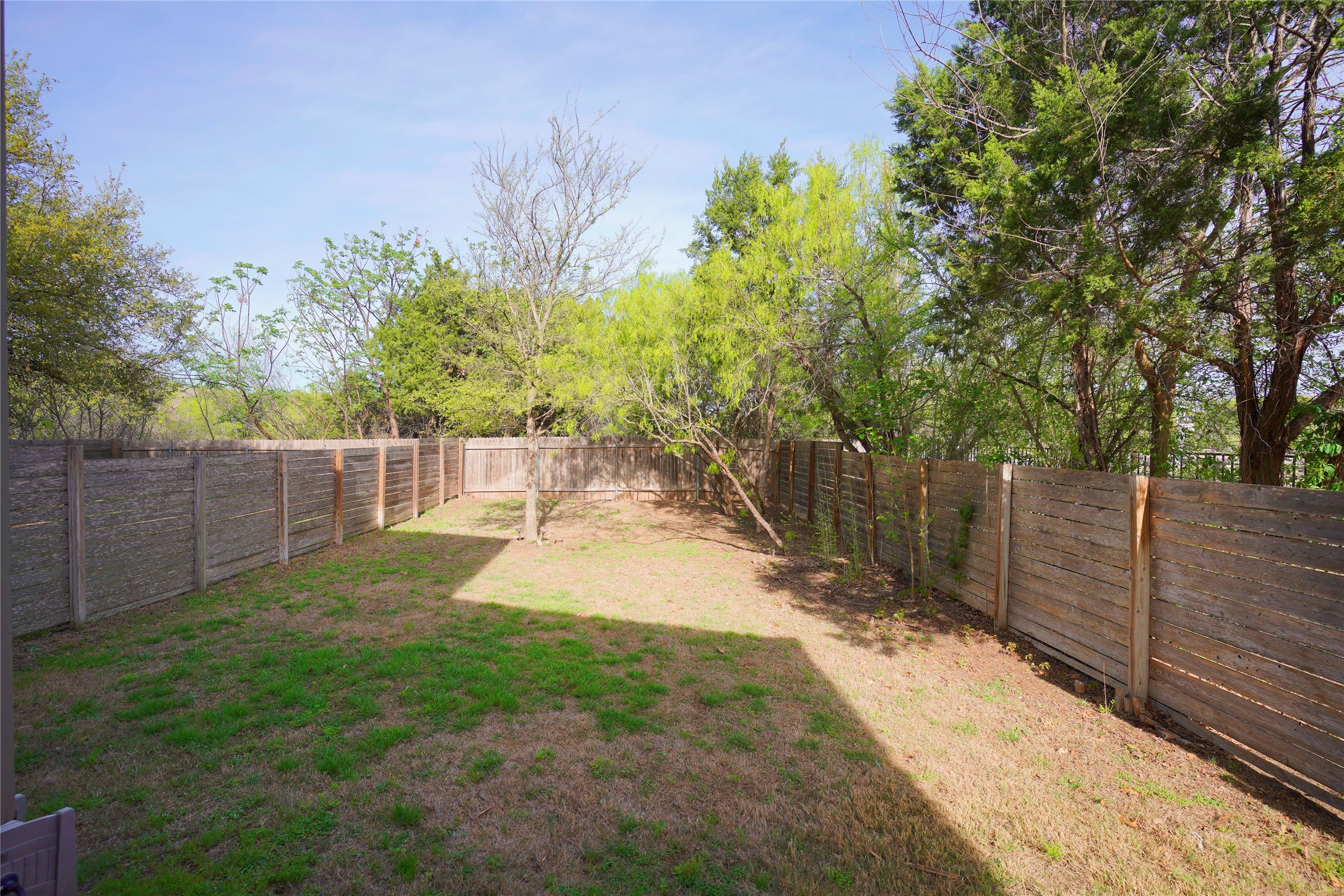8945 Parker Ranch Circle, Unit A Austin, TX 78748 - Photo 24 of 25 a view of a backyard with wooden fence