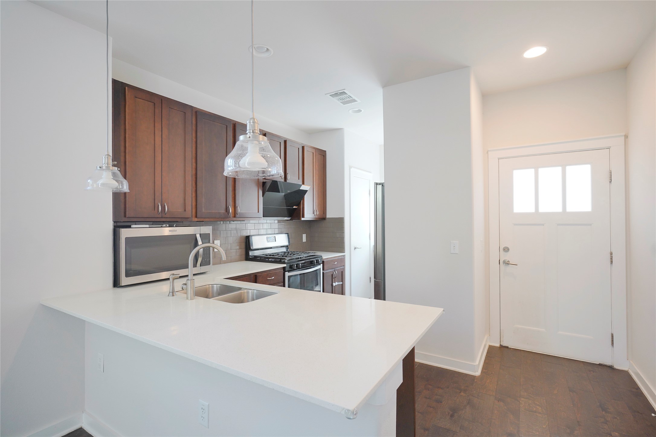 8945 Parker Ranch Circle, Unit A Austin, TX 78748 - Photo 4 of 25 a kitchen with a sink a stove and refrigerator