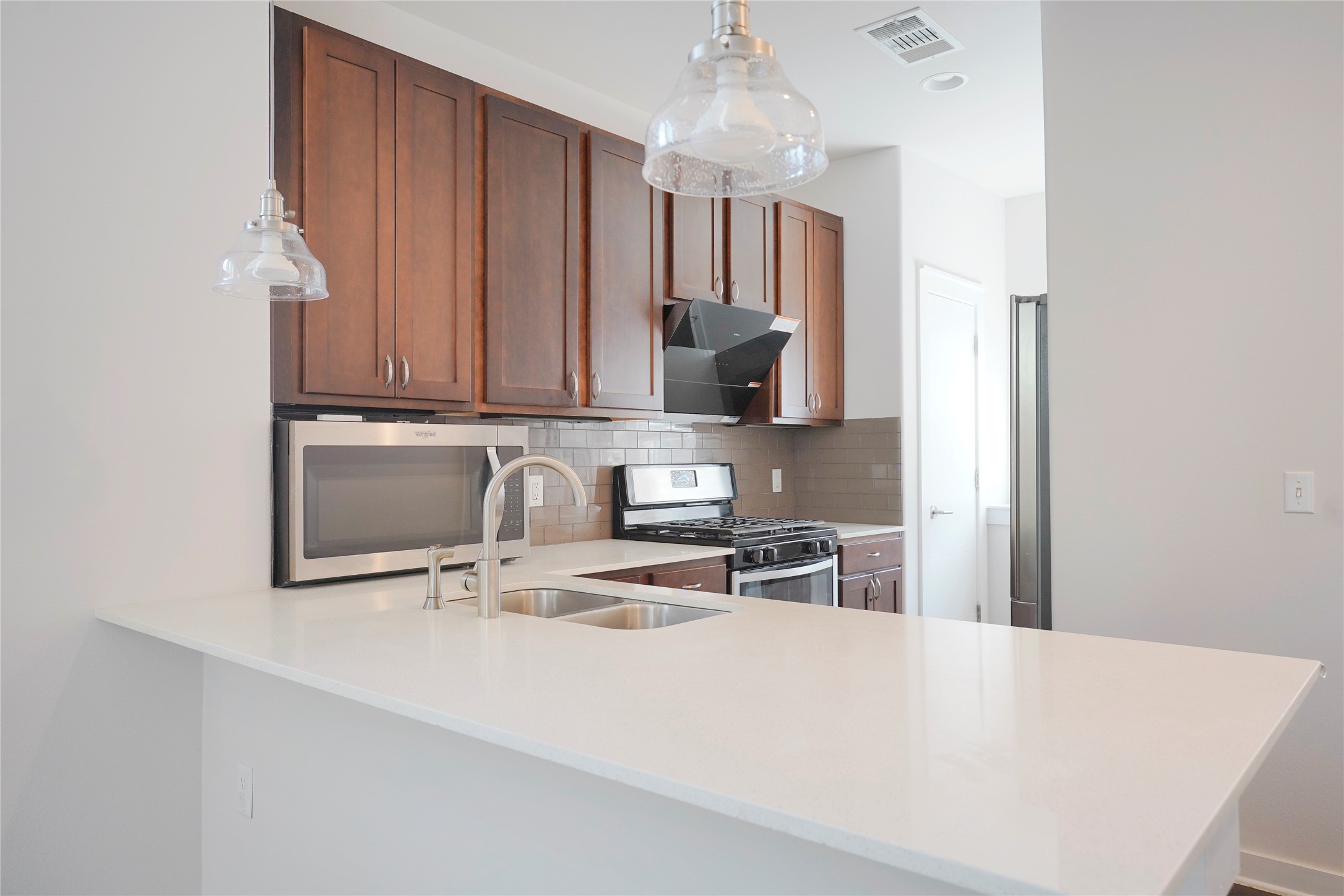 8945 Parker Ranch Circle, Unit A Austin, TX 78748 - Photo 5 of 25 a kitchen with stainless steel appliances a stove a sink a microwave and cabinets