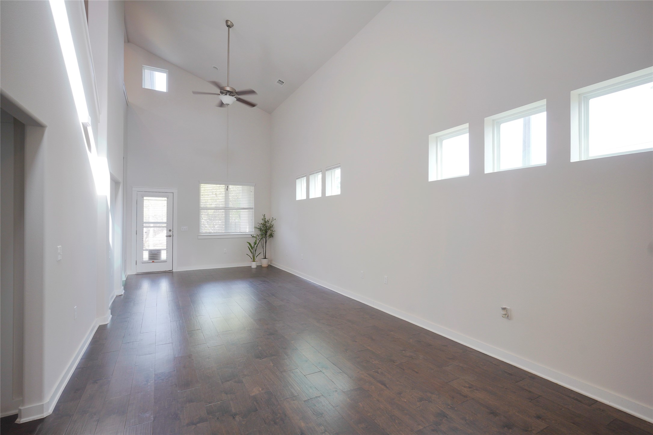 8945 Parker Ranch Circle, Unit A Austin, TX 78748 - Photo 8 of 25 an empty room with wooden floor and windows