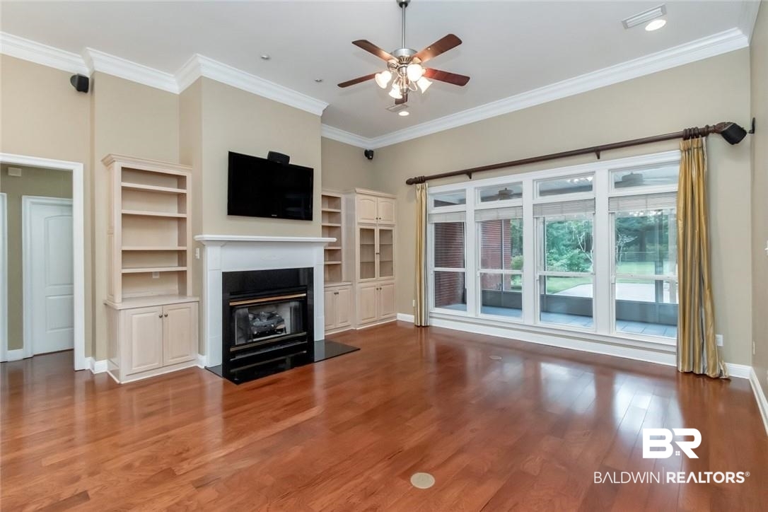 8837 Dawes Lake Road South Mobile, AL 36619 - Photo 16 of 44 Unfurnished living room with ornamental molding, ceiling fan, and dark hardwood / wood-style floors