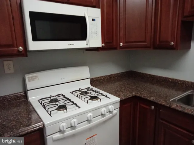 a kitchen with a stove and a microwave