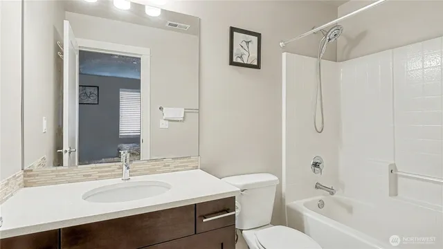 a bathroom with a sink toilet tub and shower