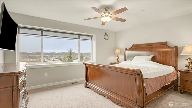 a bedroom with a bed and a large window