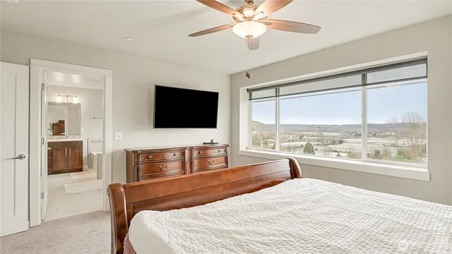 a bedroom with a bed and a flat screen tv with the outer view