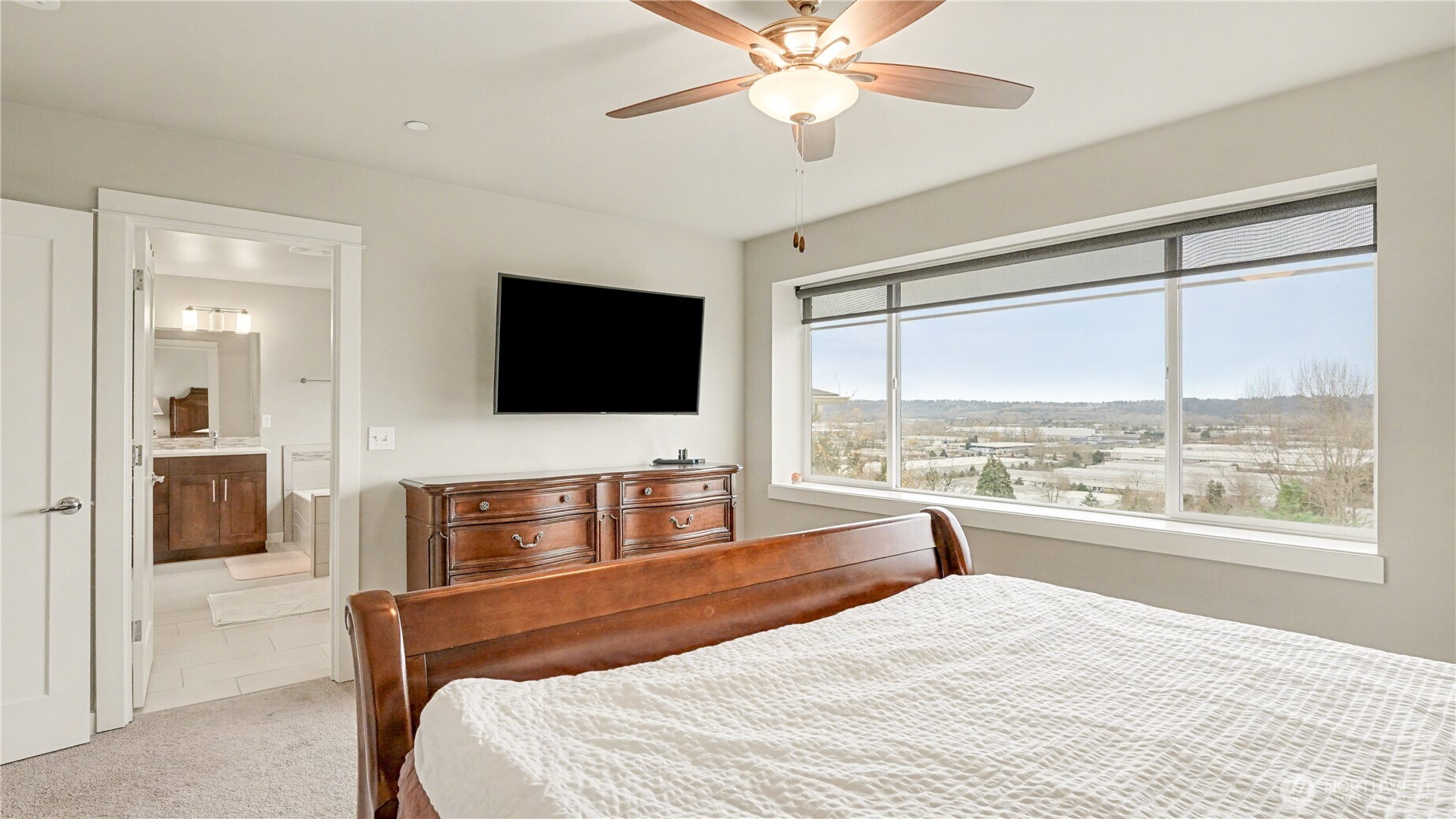 20403 93rd Place South, Unit 902 Kent, WA 98031 - Photo 23 of 40 a bedroom with a bed and a flat screen tv with the outer view