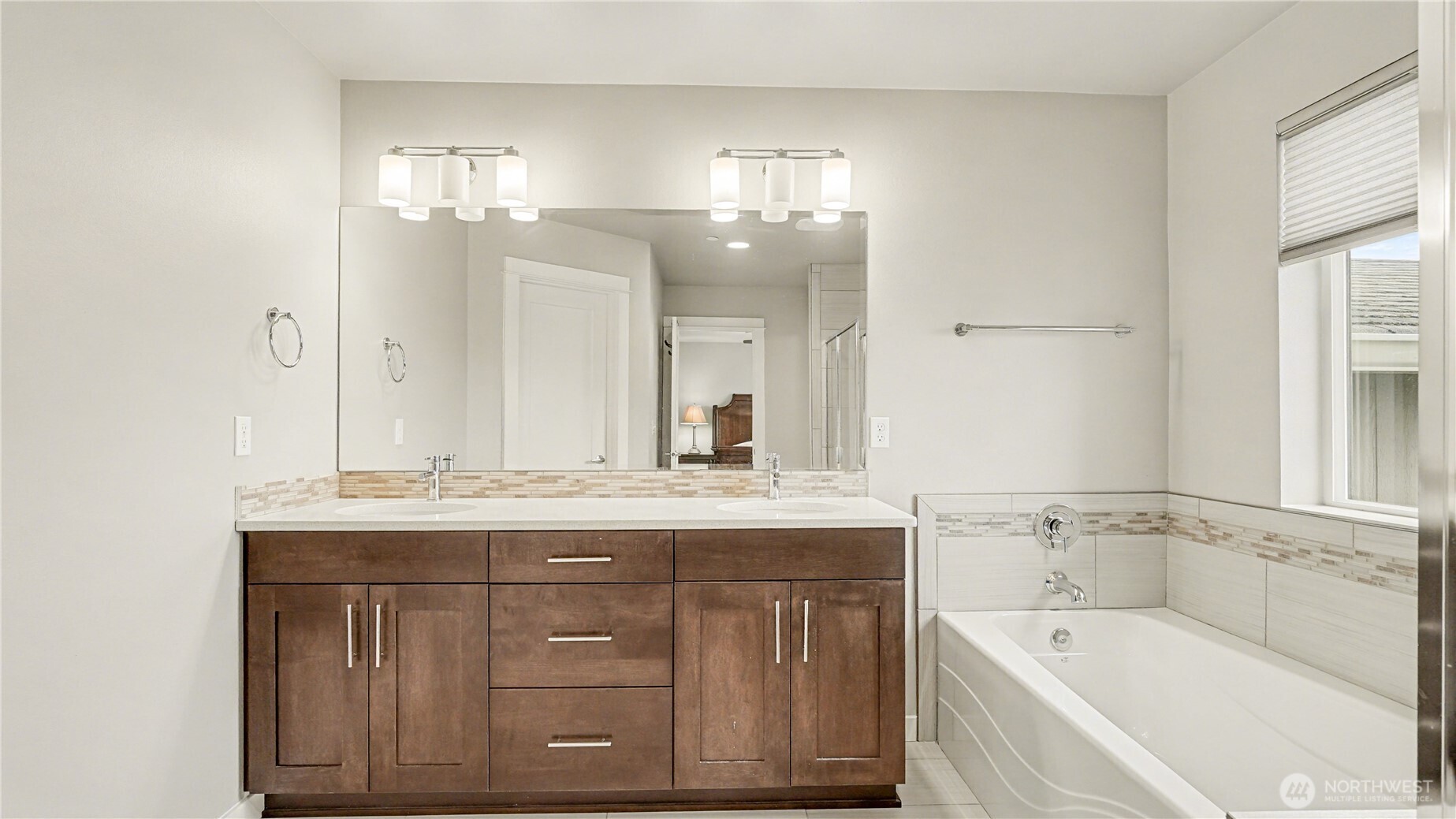 20403 93rd Place South, Unit 902 Kent, WA 98031 - Photo 24 of 40 a bathroom with a granite countertop bathtub a double vanity sink and mirror