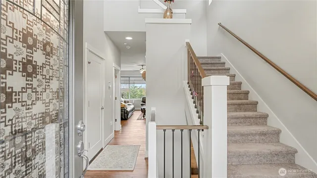 a view of a hallway with windows and stairs