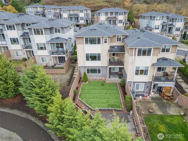 a aerial view of a brick house next to a yard