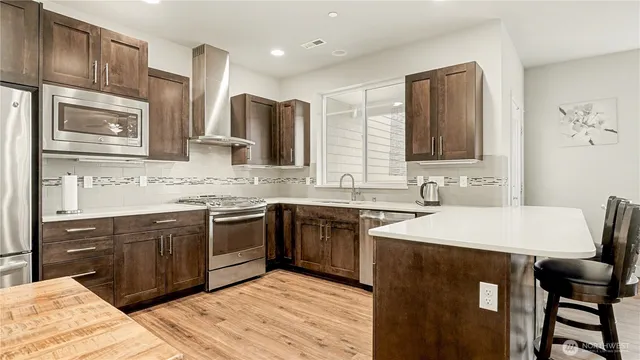 a kitchen with a sink cabinets and wooden floor