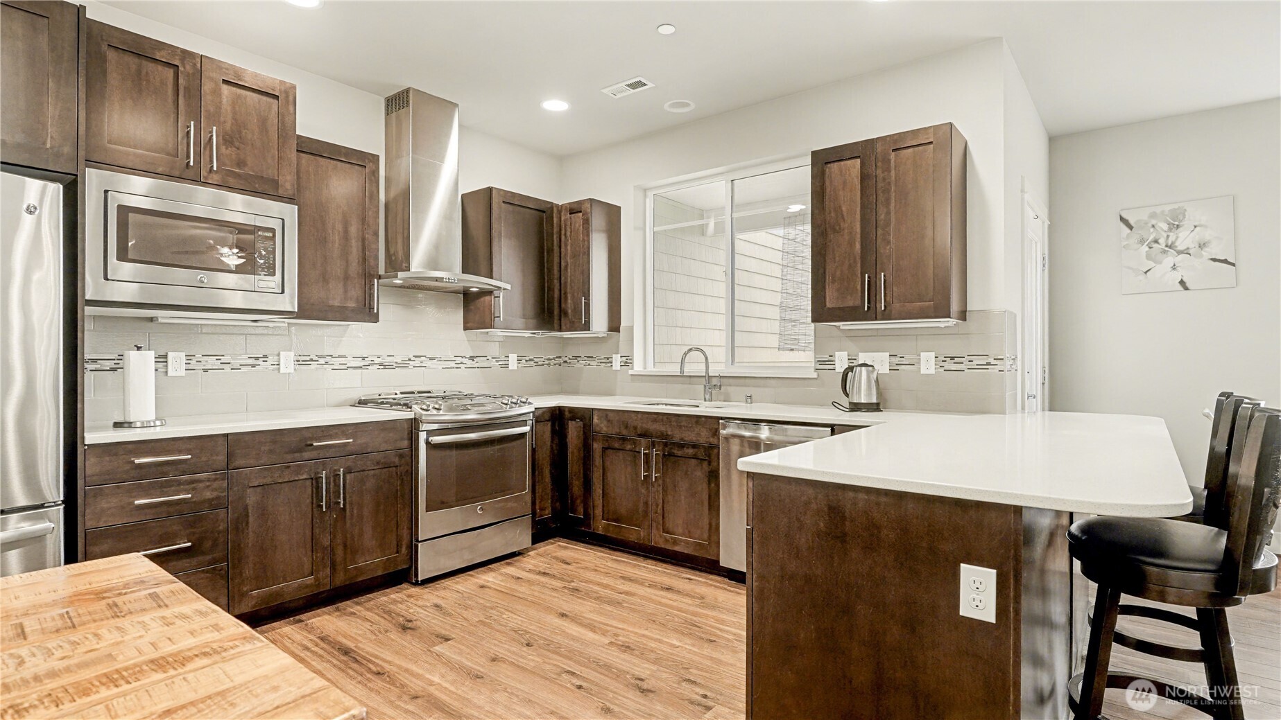 20403 93rd Place South, Unit 902 Kent, WA 98031 - Photo 9 of 40 a kitchen with a sink cabinets and wooden floor