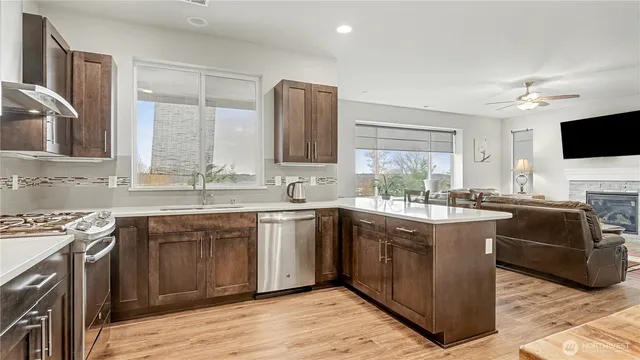 a kitchen with stainless steel appliances granite countertop a sink stove and oven