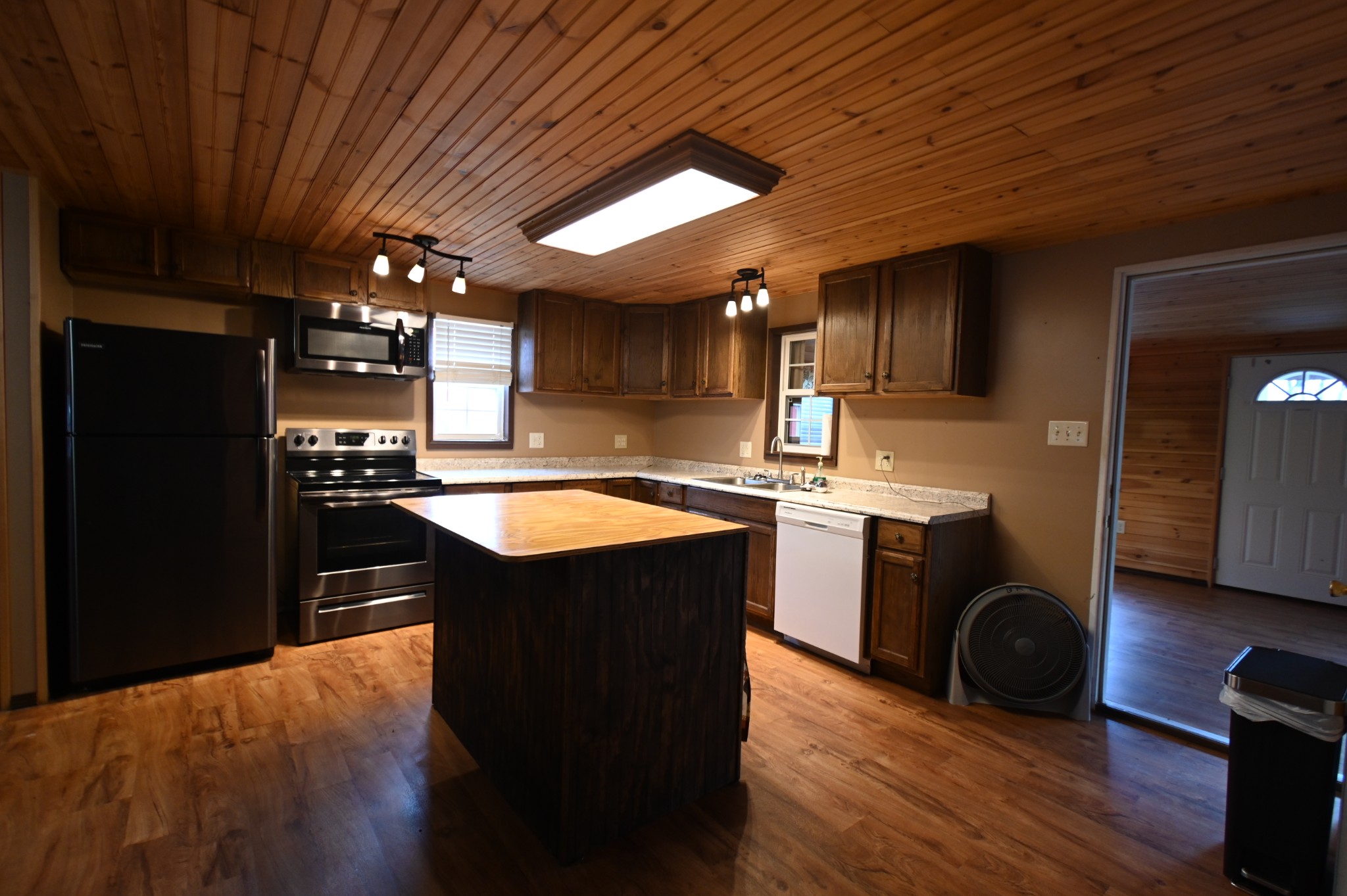 2383 Airport Ridge Road Linden, TN 37096 - Photo 47 of 64 a kitchen with wooden cabinets and black appliances