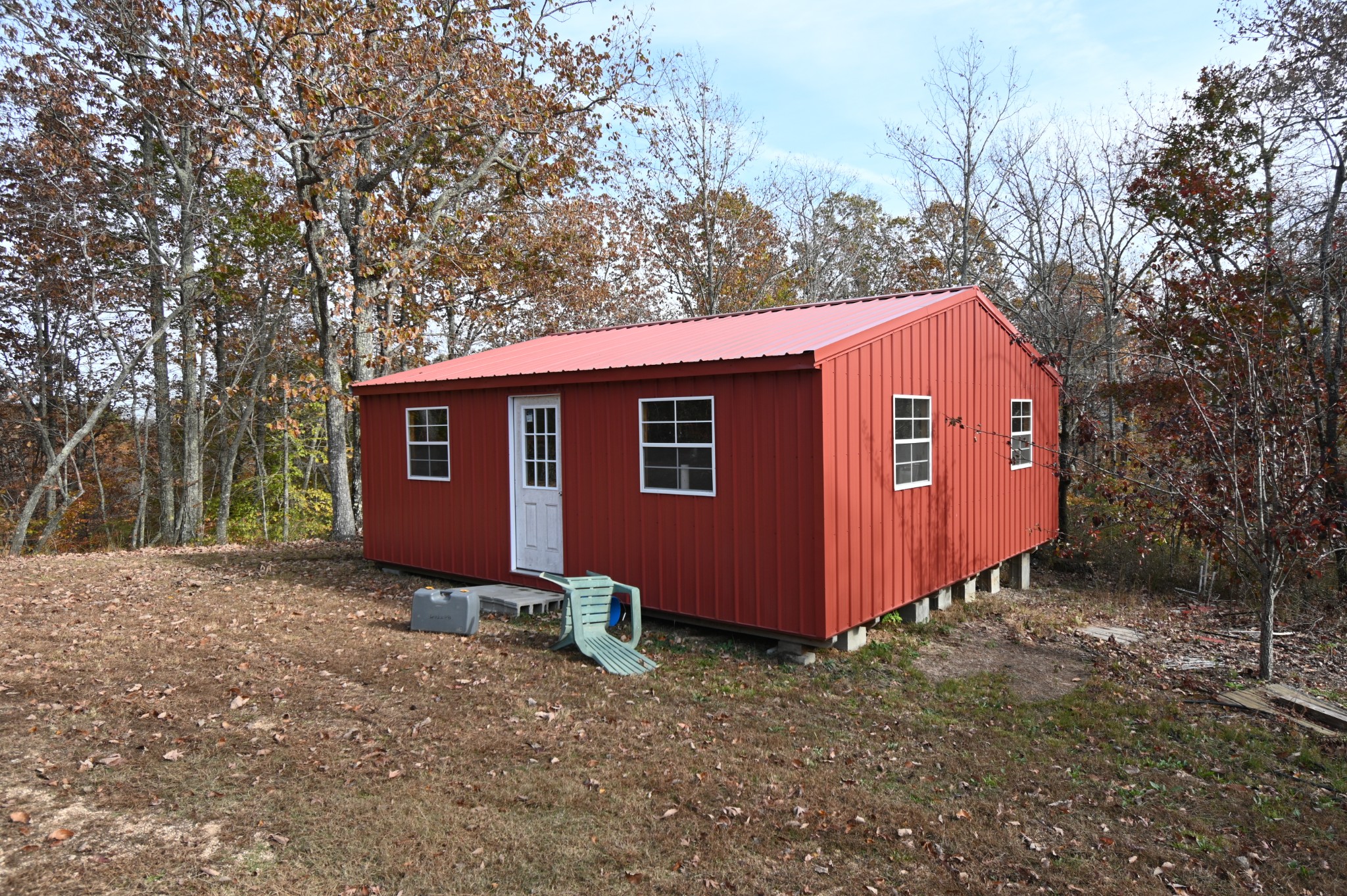 2383 Airport Ridge Road Linden, TN 37096 - Photo 9 of 64 a view of a small house with a big yard and large trees