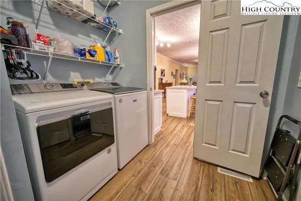 a kitchen with microwave a stove and cabinets
