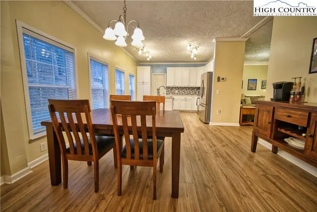 a view of wooden house with a wooden deck