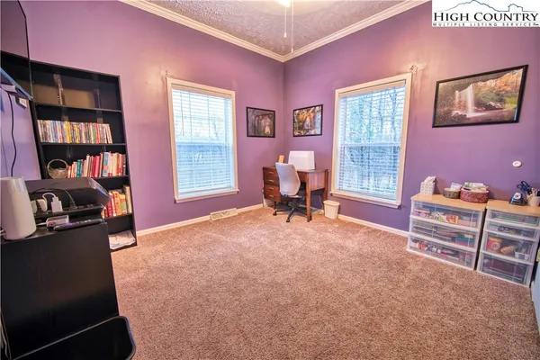 a livingroom with workspace and a window