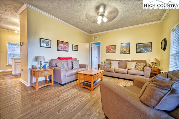 a living room with furniture and a wooden floor
