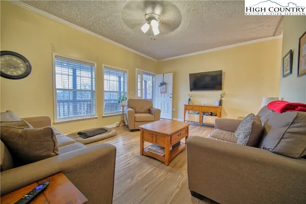 a living room with furniture and a flat screen tv