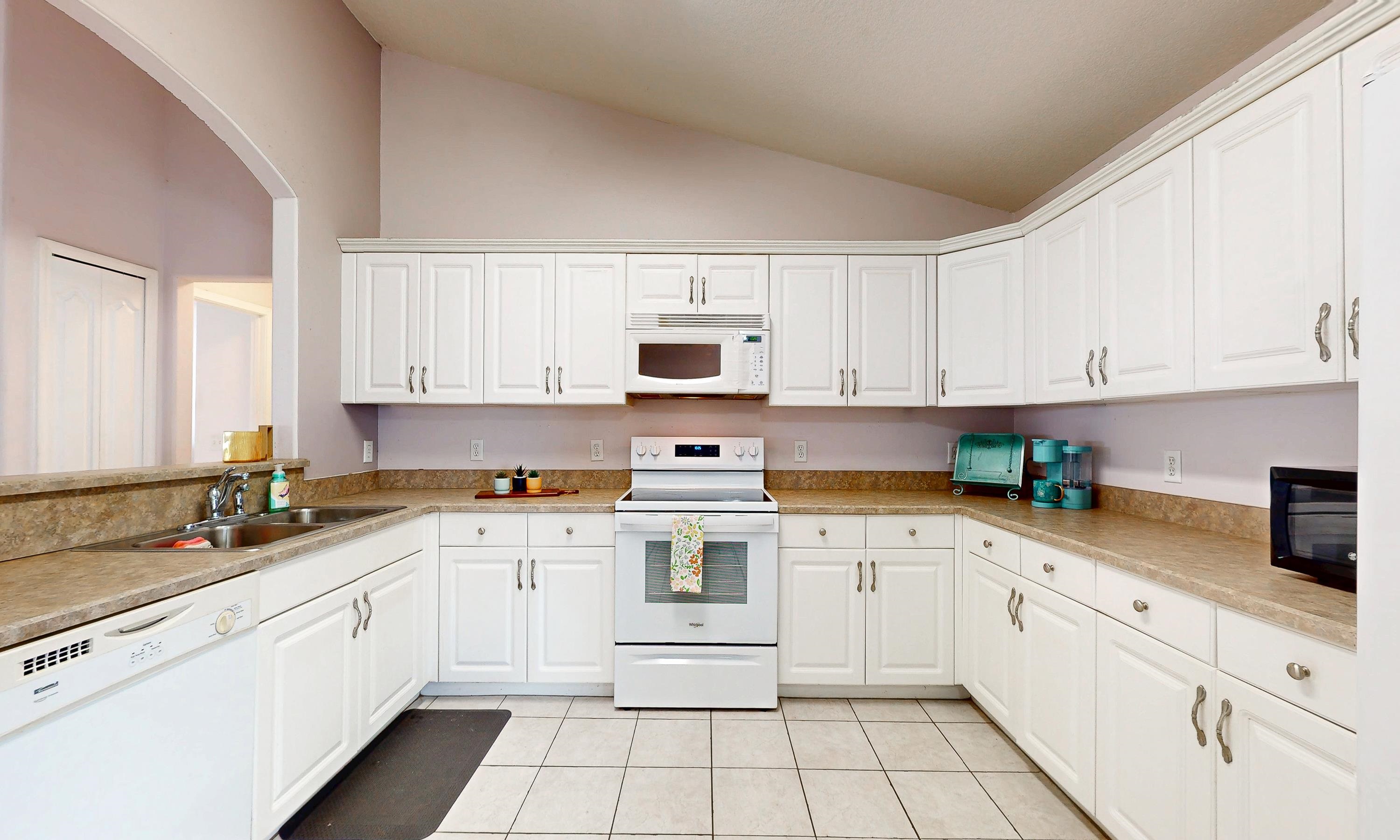 330 Segovia Road St. Augustine, FL 32086 - Photo 9 of 52 a white kitchen with granite top and stainless steel appliances
