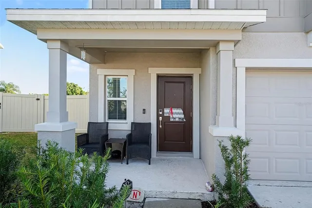 a view of a patio with table and chairs potted plants