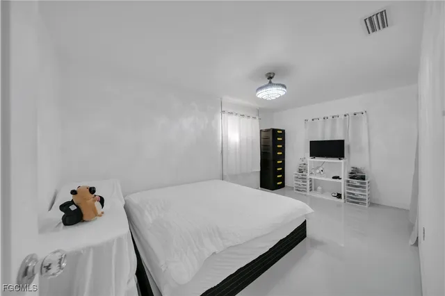 a large white bed in a white room