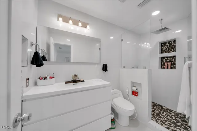a bathroom with a sink toilet and shower