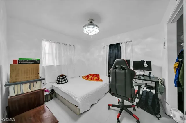 a living room with furniture a flat screen tv and a window