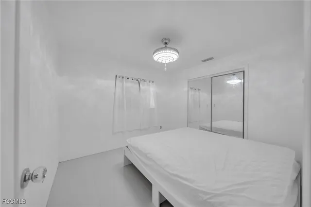 a large white bed in a white room